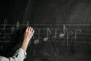 person writing on a black board